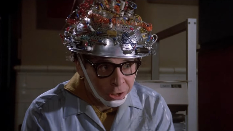 Rick Moranis as Louis Tully wearing a metal helmet for an experiment in Ghostbusters