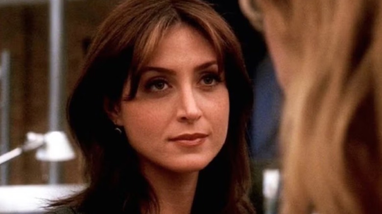 Kate Todd from Sasha Alexander is seriously looking at a blond person facing the camera in NCIS