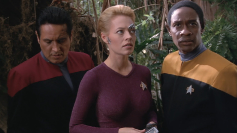 Chakotay, seven of the nine and Tukov on a forest planet.