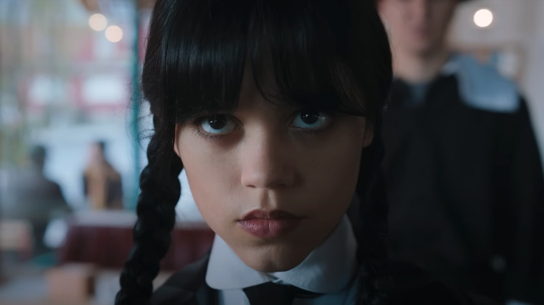 Jenna Ortega glaring in a cafe in Wednesday