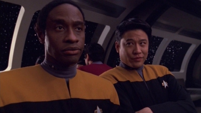 Tuvok and Harry Kim from Star Trek: Voyager standing in the ship's commissary, with Harry looking jauntily at Tuvok