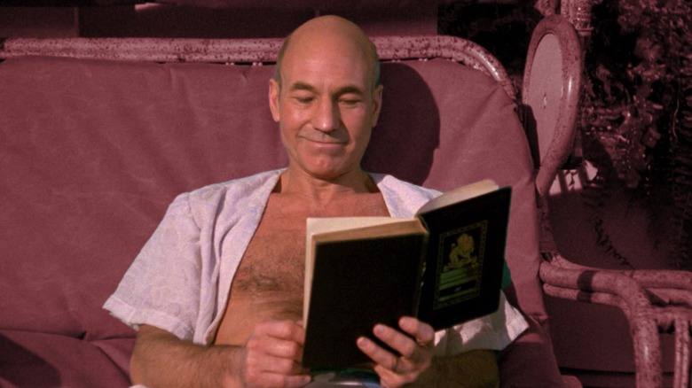 Captain Picard enjoying a book and smirking because he looks so fly