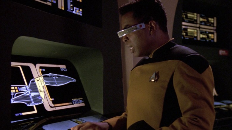 LeVar Burton as Geordi looking at a diagram of the Enterprise in Star Trek: The Next Generation