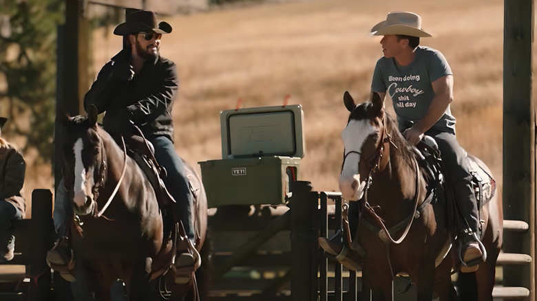 Rip Wheeler and Travis Wheatley sitting on the horses of Yellowstone