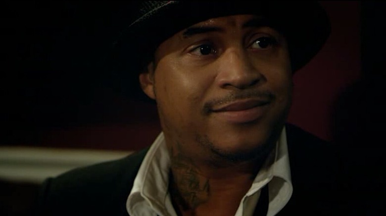 Orlando Brown as Charles in a suit and hat in American Bad Boy