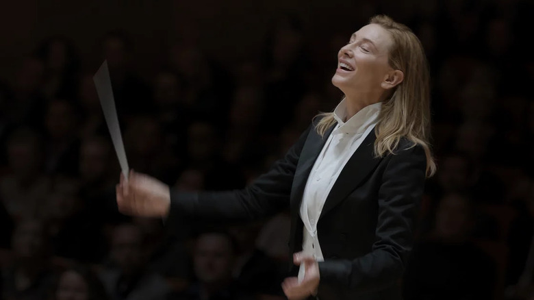 Lydia Tár, conducting in a suit.