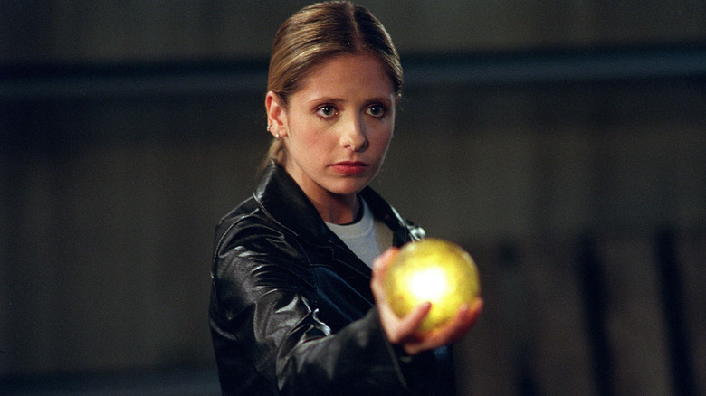 Buffy holding a glowing yellow orb