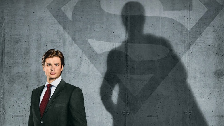 Smallville Season 10 poster showing Clark Kent casting shadow of Superman with S-Insignia in the background