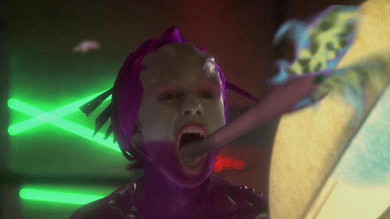 An alien burlesque performer eating a butterfly with her frog tongue on Star Trek: Enterprise