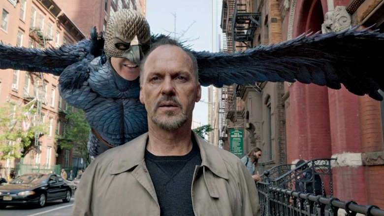 Birdman flying behind man