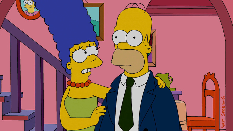 The Simpsons Marge puts her hand on Homer's shoulder as he stares blankly