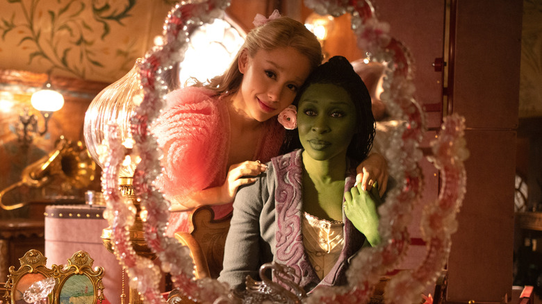 Glinda and Elphaba looking into a pink mirror in Wicked