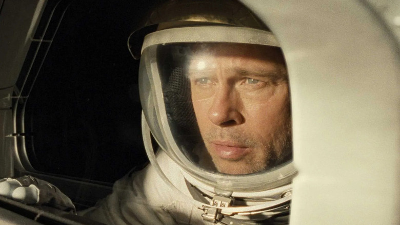 Brad Pitt as Roy McBride stares out of his shuttle window in Ad Astra