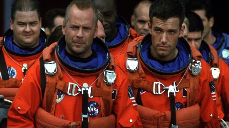 Harry Stamper (Bruce Willis) and AJ Frost (Ben Affleck) walk with their drilling astronaut crew in Armageddon