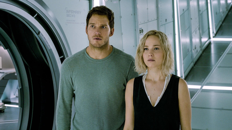 Jim (Chris Pratt) and Aurora (Jennifer Lawrence) stand together on the Avalon in Passengers