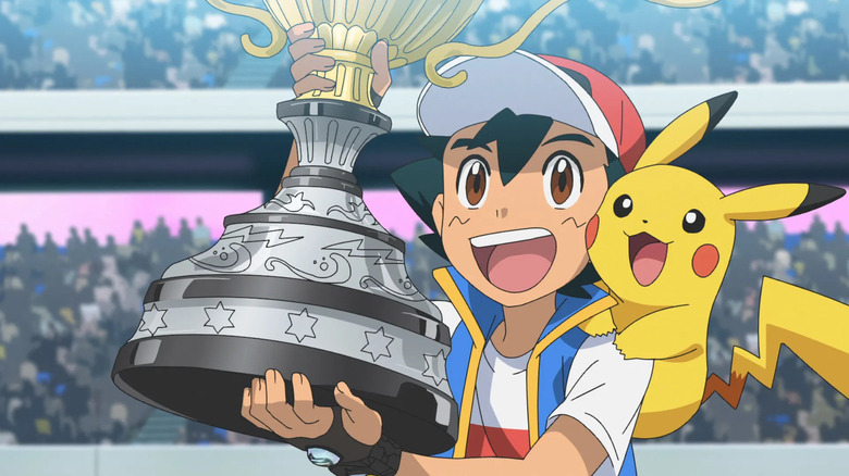 Pokemon Journeys Ash and Pikachu holding championship trophy