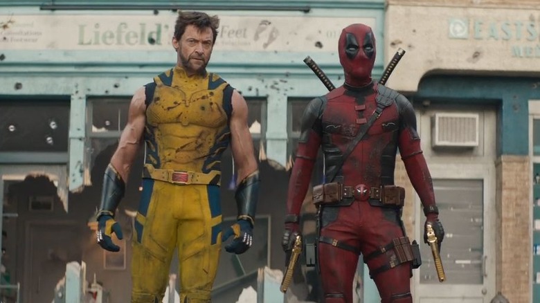 Deadpool and Wolverine walking near storefronts