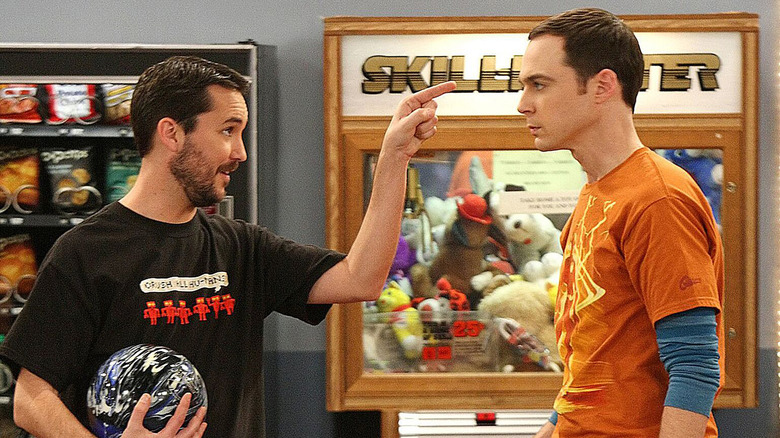 Wil holding a bowling ball and pointing at Sheldon on The Big Bang Theory