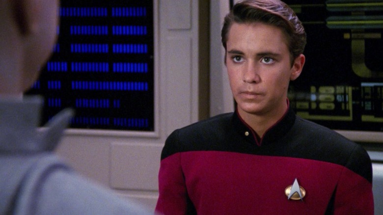 Wesley Crusher, standing in main engineering, looking stressed.