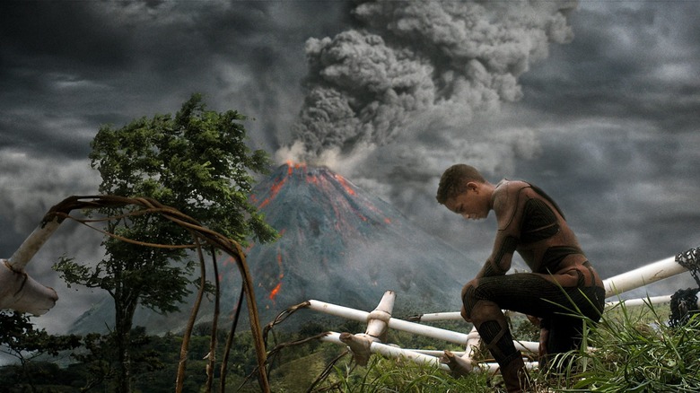 Jaden Smith kneeling down in front of a volcano