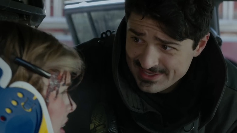 Yuri Sardarov's Otis helps a woman in a neck brace in Chicago Fire