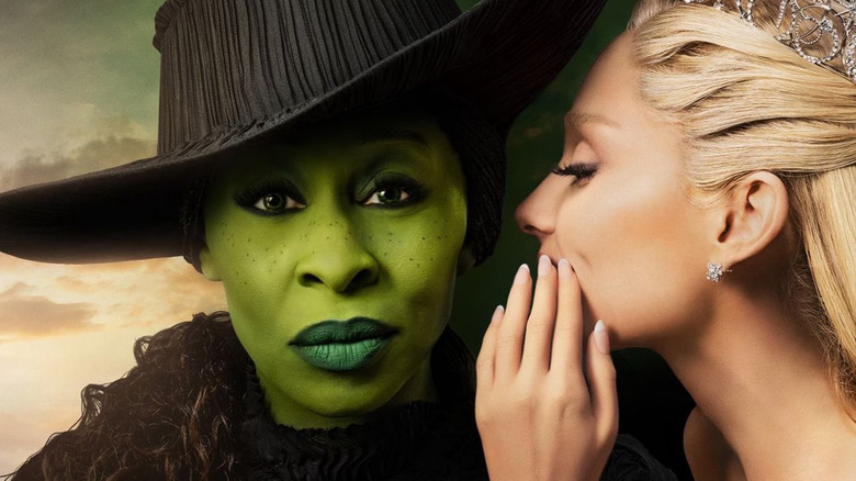 Glinda whispering in Elphaba's ear in the poster art for Wicked