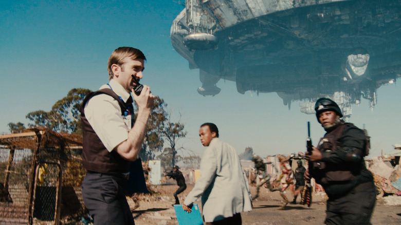 Sharlto Copley using a walkie-talkie in District 9