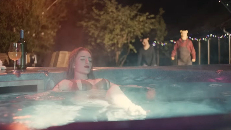 Piglet and Pooh standing menacingly behind a woman in a hot tub