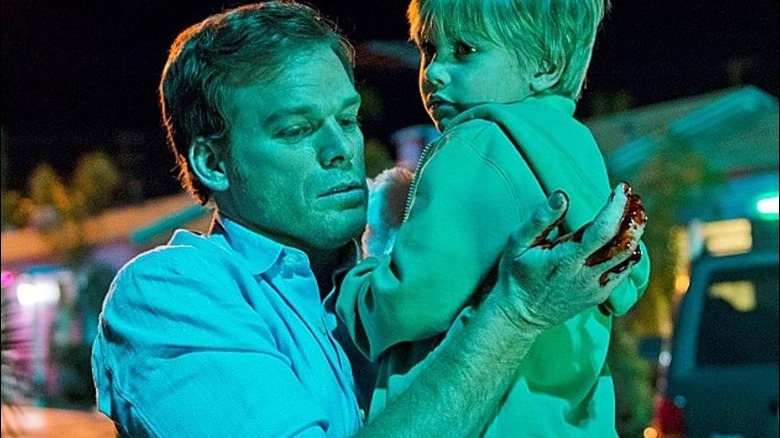 Bloodied Dexter carries baby Harrison