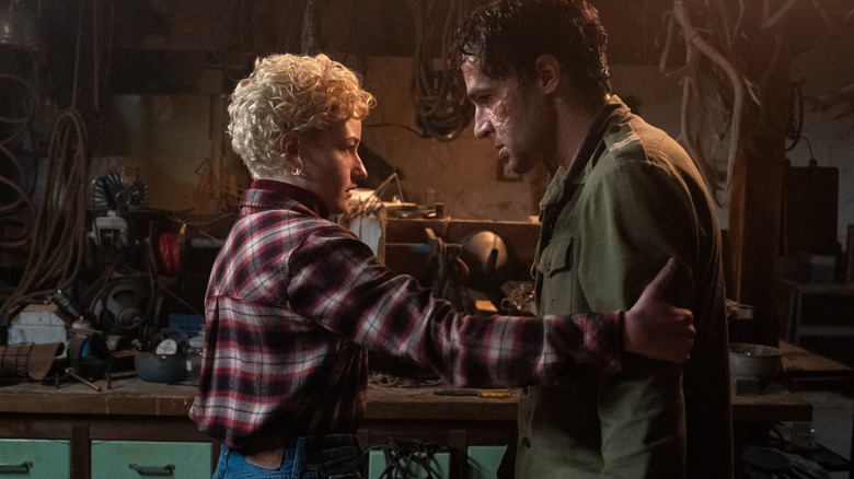 Christopher Abbott as Blake in the early stages of transformation while Julia Garner as Charlotte looks on in Wolf Man