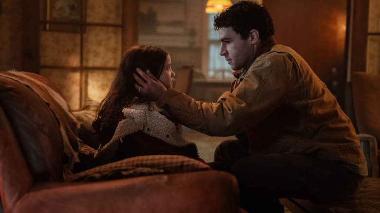 Christopher Abbott as Blake comforting his daughter Ginger (Matilda Firth) in a scene from Wolf Man