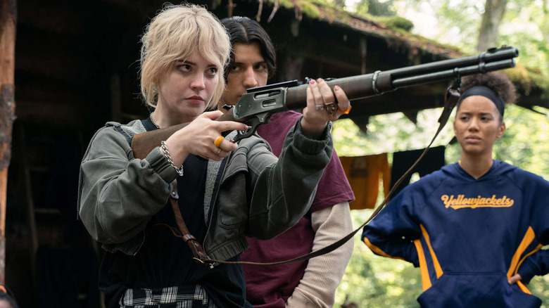 Natalie takes aim with Travis and Taissa in Yellowjackets