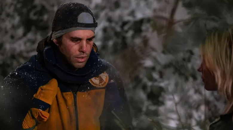 Coach Ben and Natalie in the wintery forest on Yellowjackets