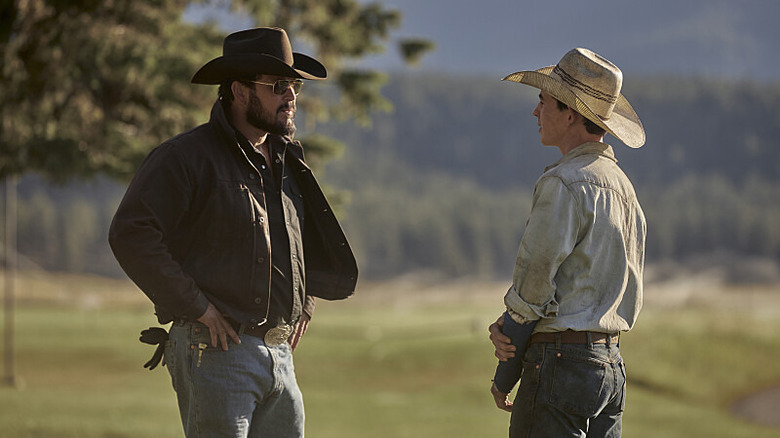 Rip Wheeler converses with a colleague outside on the Yellowstone ranch