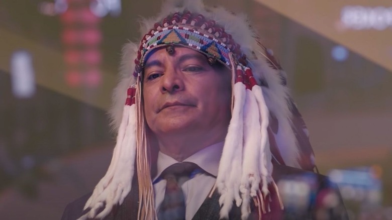 Thomas Rainwater wearing a traditional Native headdress in Yellowstone