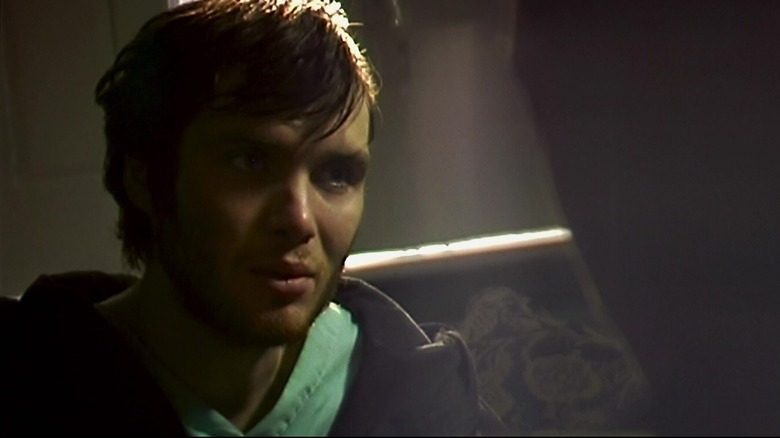 Cillian Murphy's Jim stands in shadow in 28 Days Later