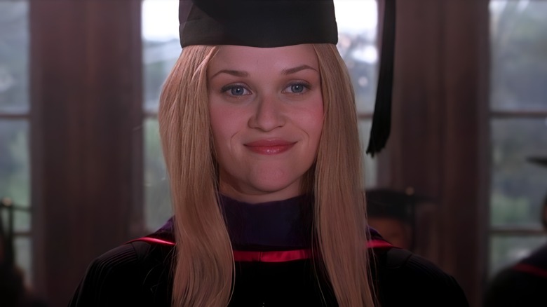 Elle Woods smiling and wearing graduation gear in Legally Blonde