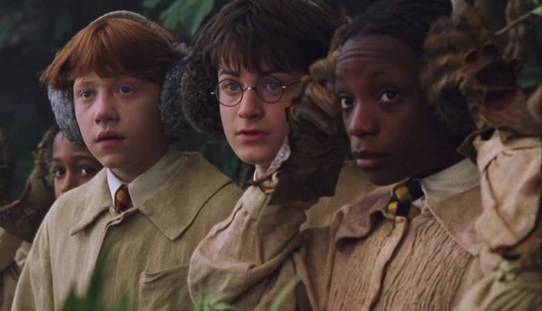 Kathleen Cauley as Lavender Brown next to Daniel Radcliffe and Rupert Grint as Harry Potter and Ron Weasley in Herbology class with earmuffs on