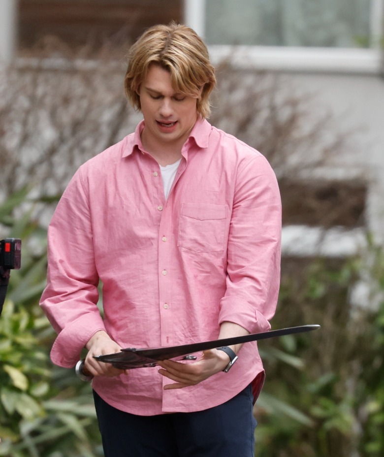 Nicholas Galitzine as Prince Adam holding a sword on all the masters of the universe